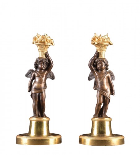 Elegant Louis XVI figural candlesticks with cupid figures