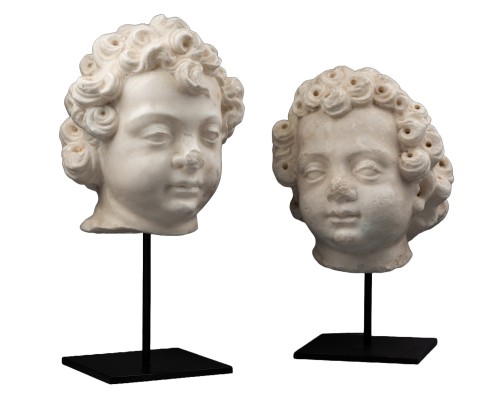 A 16th century North Italian marble heads of two puttis