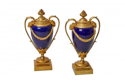 A pair of cassolettes forming an ovoid-shaped candlestick in blue porcelain