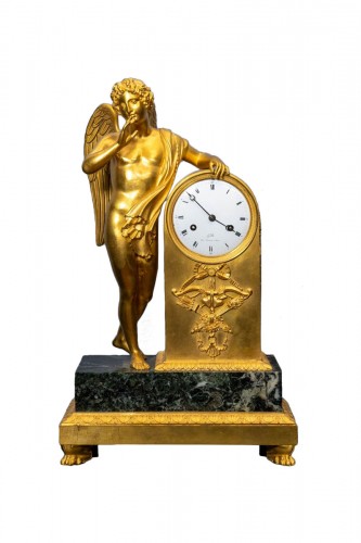 An Empire gilt bronze and green marble figural mantel clock