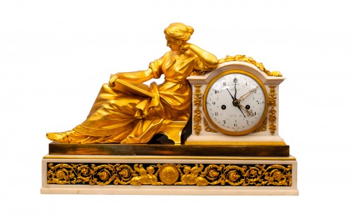 A Louis XVI gilt bronze and ebony pendule a la Geoffrin