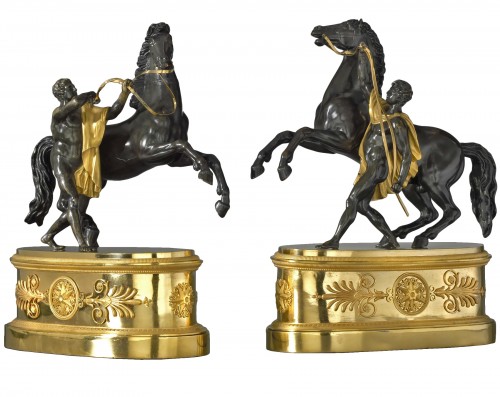 A pair of Empire gilt and patinated bronze statuettes
