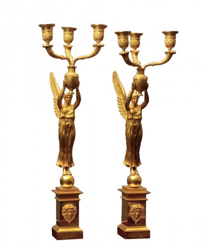 A pair of Empire figural gilt bronze three light candelabras