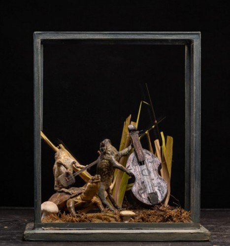 A cased taxidermy display of the Toad and Frog orchestra  playing music - 