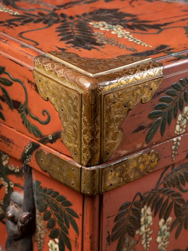 A large red lacquer chest (karabitsu) decorated with monkeys in relief - 