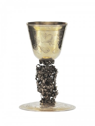 A parcel-gilt cup on foot engraved with fruits and vegetables